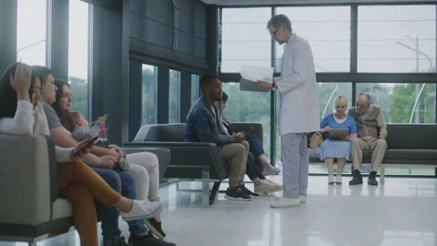 Diverse people sit on sofas in clinic lobby area Stock Footage 249743747