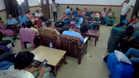 Diverse people sit on sofas in clinic lobby area, wait for doctors appointment. Stock Footage 257049820
