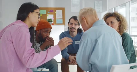 Diverse people supporting senior crying woman at therapy session Stock Footage 154137116