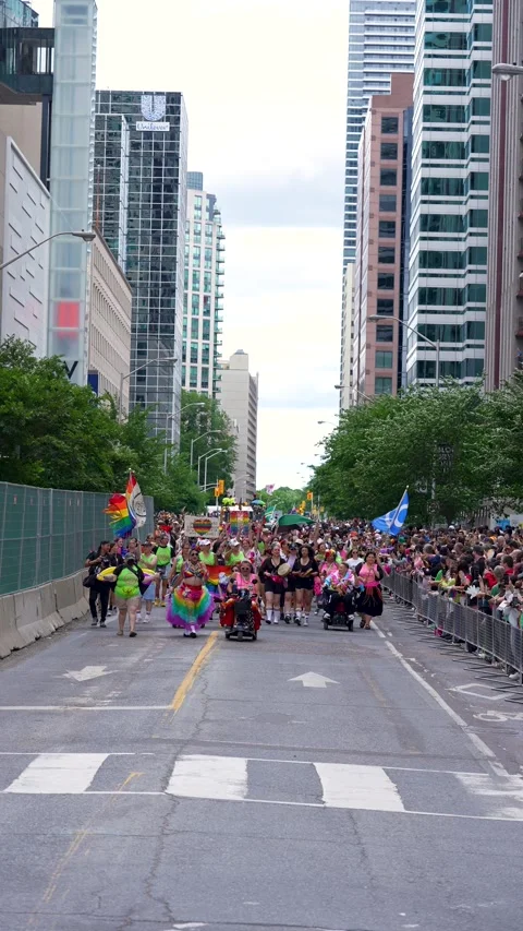 Diverse Pride Parade Participants Marching with Flags in Toronto Video stock 332018054