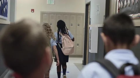 Diverse Primary and Elementary school children walk school hall in uniforms. Video stock 139655667