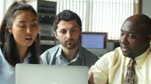 Diverse professional team seated in front of office laptop Stock Footage 49195076