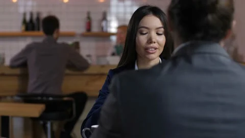 Diverse professionals chatting during coffee break Stock Footage 100687980