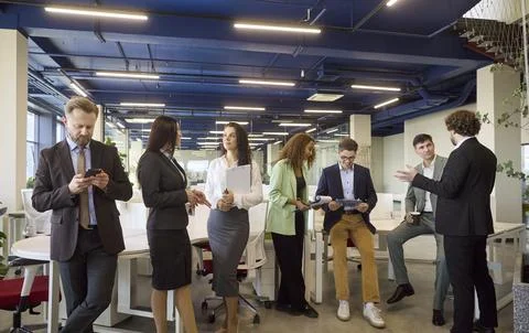 Diverse professionals networking and collaborating in a bright modern office Stock Photos