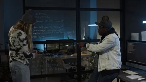 Diverse Programmers Brainstorming and Writing Code on Glass Wall in Office Video stock 273833764