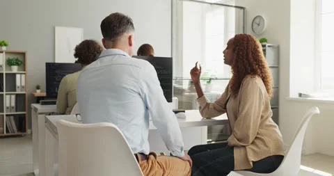 Diverse programmers collaborating on code in open office during team discussion 스톡 동영상 337978815
