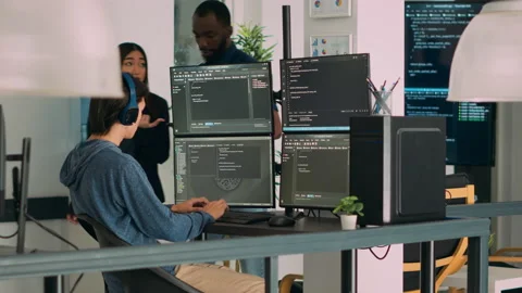 Diverse programmers collaborating on coding project compiling algorithm Stock Footage 220705890