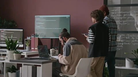 Diverse Programmers Discussing Algorithm ding by Glass Panel with Code in Office Stock Footage 285713739