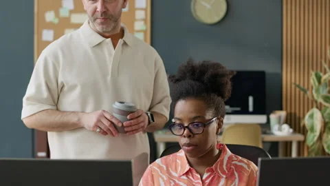 Diverse Programmers Discussing Work during Teaching Process Stock-Footage 306845930