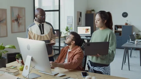 Diverse Programmers Standing around Computer, Discussing Project Video stock 293125070