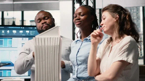 Diverse real estate developers analyze zoning regulations for construction Stock Footage 316648052