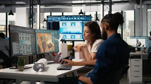 Diverse real estate developers team reviewing infrastructure layouts Stock Photos