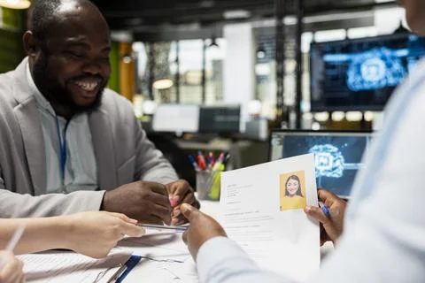 Diverse recruiters using deep learning pc software for profile evaluation Stock Photos