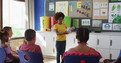 Diverse schoolboy making presentation for his colleagues how to recycle plastic Stock Footage 155443541