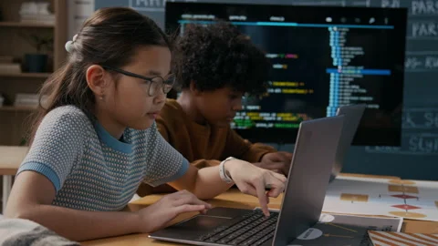 Diverse Schoolchildren Writing Computer Code on Laptops at Lesson Stock Footage 306979761