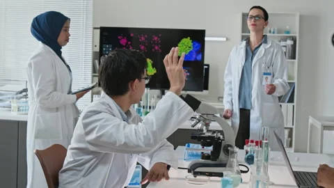Diverse Scientists Analyzing Medical Data during Lab Presentation Stock Footage 347049761