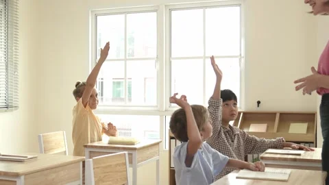 Diverse smart student raised hands to answer question at classroom. Pedagogy. Stock Footage 273845898