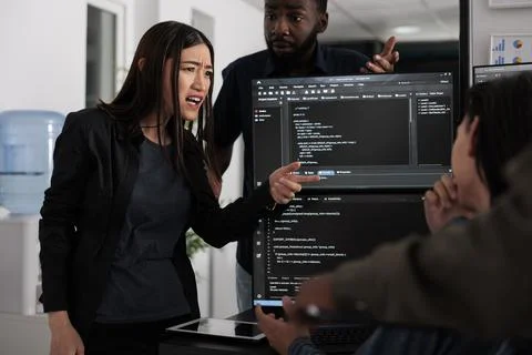 Diverse software developers analyzing html code and database Stock Photos