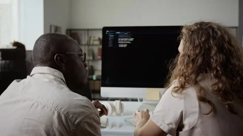 Diverse Software Developers Discussing Code at Office Computer Stockbeeldmateriaal 348149450