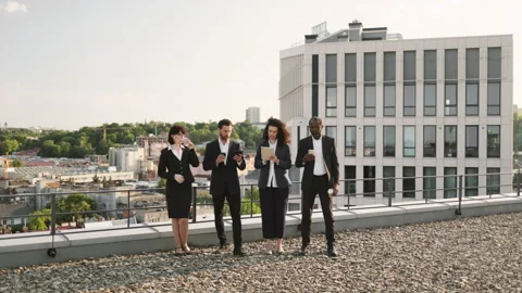 Diverse specialists taking coffee break on fresh air Stock Footage 246086229