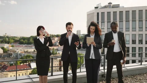 Diverse specialists taking coffee break on fresh air Stock Footage 246086664