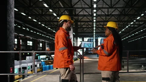 Diverse staff supervises autonomous robot arm system on laptop software Stock Footage 330140547