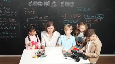 Diverse student writing engineering code while boy fixing board. Erudition. Stock Footage 279894434