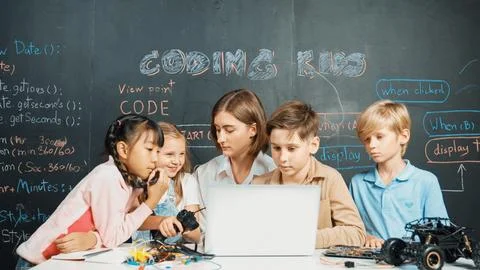 Diverse student writing engineering code while boy fixing board. Erudition. Foto stock
