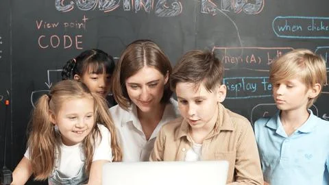 Diverse student writing engineering code while boy fixing board. Erudition. Foto stock