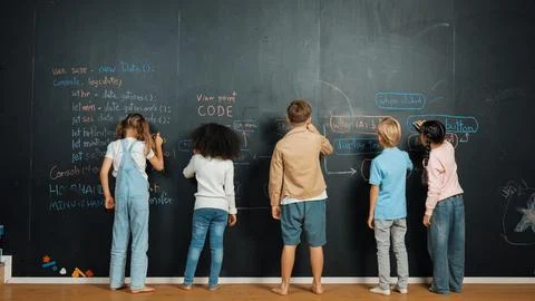 Diverse student writing engineering code or prompt at blackboard. Erudition. Stock Photos