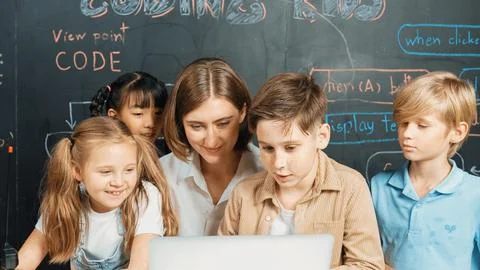 Diverse student writing engineering code while boy fixing board. Erudition. Stock Photos