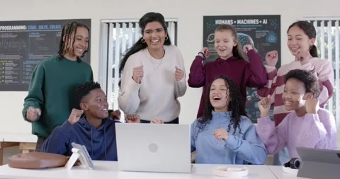Diverse students with female mentor in STEM lab reacting to laptop showing code Stock Footage 341063298