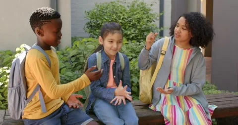 Diverse students playing hand game boy extending hand girl counting passing time Stock Footage 344253958