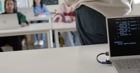 Diverse students sitting in classroom watching presenter stepping forward, Stock Footage 341029049
