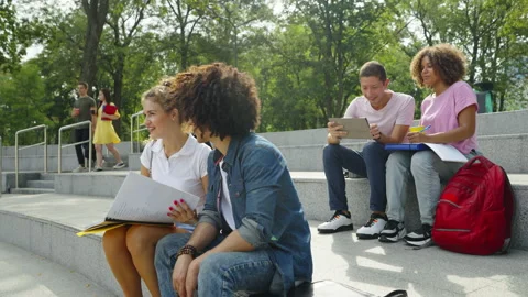 Diverse students spending time on campus on sunny day Stock Footage 160927432