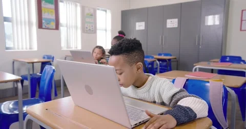 Diverse students working, African American boy seeing laptop leaning tapping Stock Footage 340631419