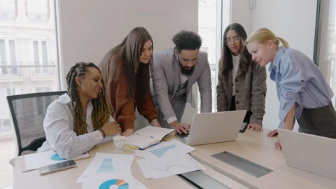 A Diverse Team Actively Collaborating Together in a Modern and Dynamic Office Stock Footage 305443675