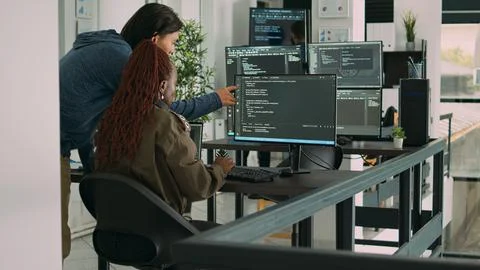 Diverse team of ai cloud programers talking about coding script in front of 스톡 사진