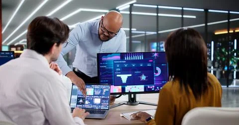 Diverse Team Of Analysts Collaborates Using Data Analytics And Technology In  Stock Photos