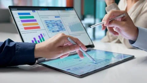 Diverse Team Of Analysts Using Multiple Screens To Monitor Business Performan Stock Photos