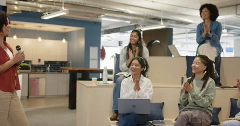 Diverse team clapping after African American woman speaker pausing at work talk Stock Footage 345750469