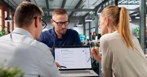 Diverse Team Collaborates On AI-powered Software Using Laptops And Cloud Syst 写真素材