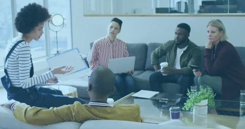 Diverse team collaborates in office, emphasizing teamwork and digital global Stock Footage 328586522