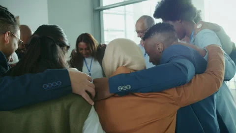 Diverse team collaborating and demonstrating unity in a supportive corporate Stock Footage 341317173