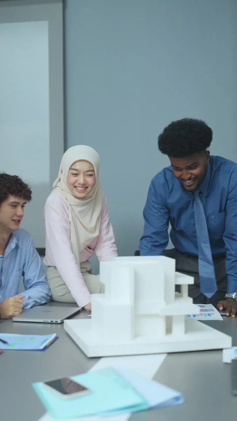 Diverse Team Collaborating on Architectural Design Project Stock Footage 286066214