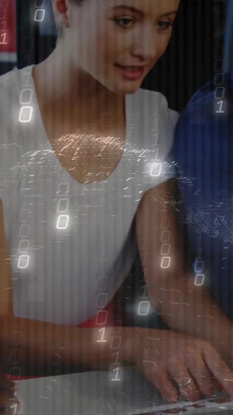 Diverse team collaborating on laptop with binary code animation overlay 動画素材 344404086