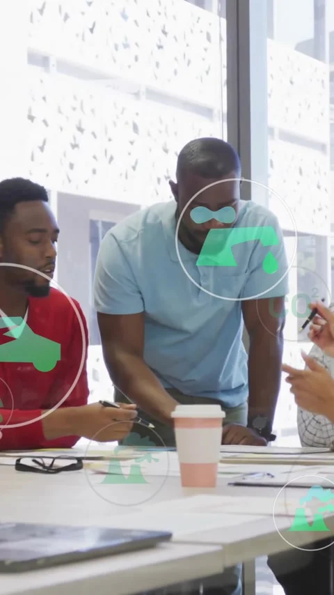 Diverse team collaborating at office with eco-friendly icons overlay animation Stock Footage 344244767