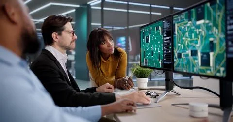 Diverse Team Collaborating On PCB Design, Developing New Technology Solutions Stock Photos