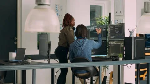 Diverse team of database admins analyzing source code and comparing data script 스톡 사진