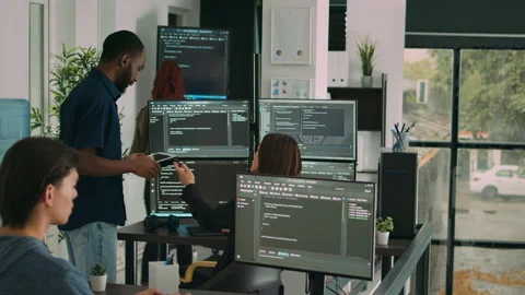 Diverse team of database developers analyzing code on terminal window Stock Footage 217407899